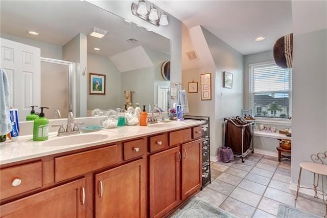 bathroom with vaulted ceiling, tile flooring, oversized vanity, and double sink