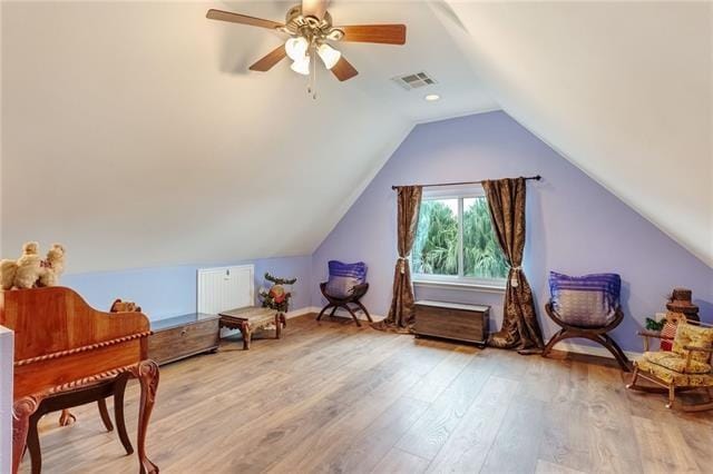 interior space with ceiling fan, hardwood / wood-style floors, and lofted ceiling