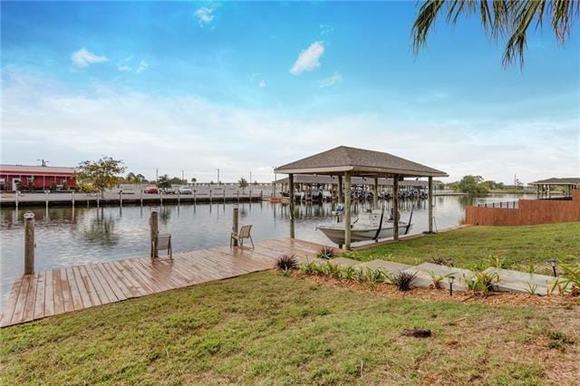 dock area featuring a water view and a lawn