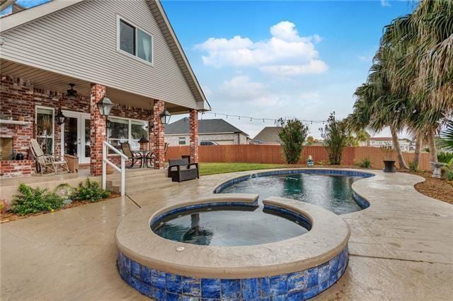 view of pool with french doors, an in ground hot tub, and a patio