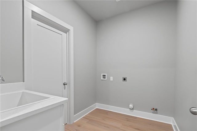 clothes washing area with gas dryer hookup, washer hookup, electric dryer hookup, and light wood-type flooring