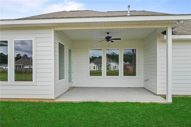 back of house with a lawn, ceiling fan, and a patio area