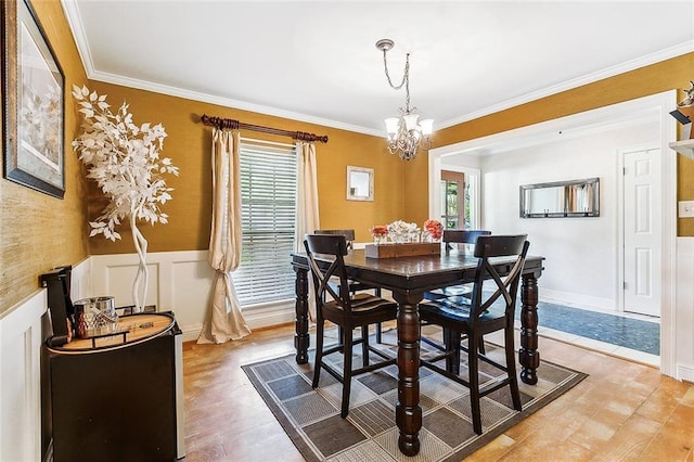 dining area featuring a chandelier, a wealth of natural light, and ornamental molding