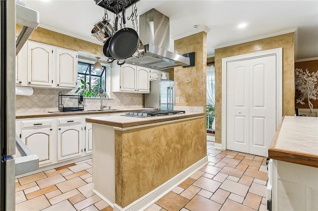 kitchen with a center island, stainless steel appliances, tasteful backsplash, island exhaust hood, and white cabinets