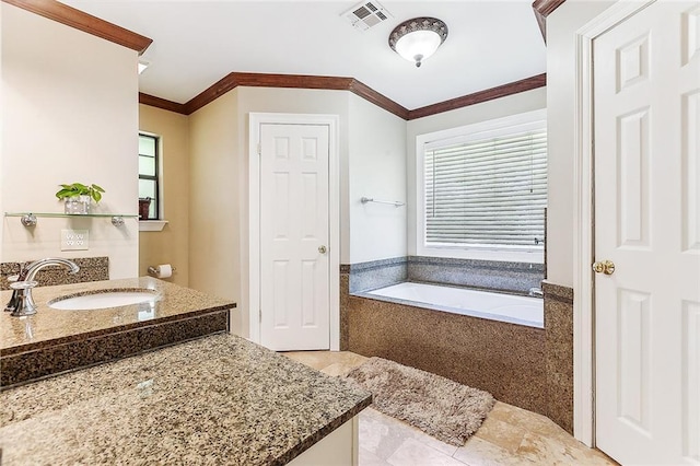 bathroom featuring tiled tub, crown molding, and vanity