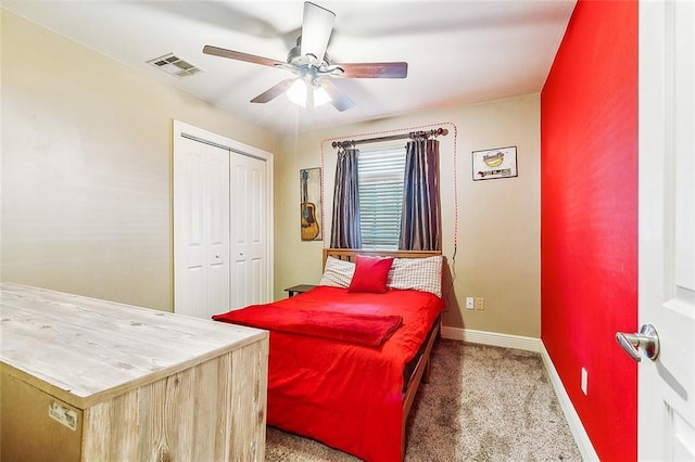 carpeted bedroom with ceiling fan and a closet