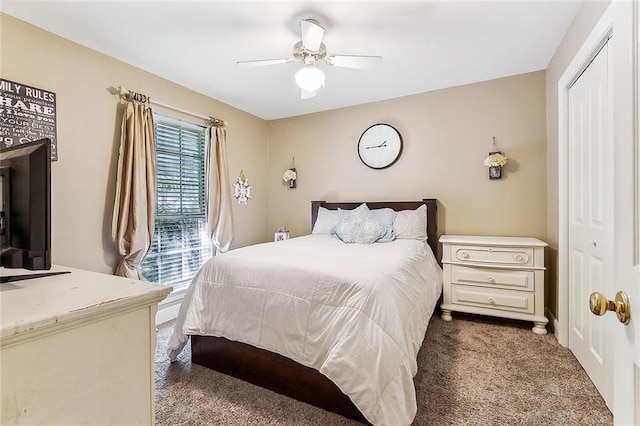 carpeted bedroom with ceiling fan and a closet