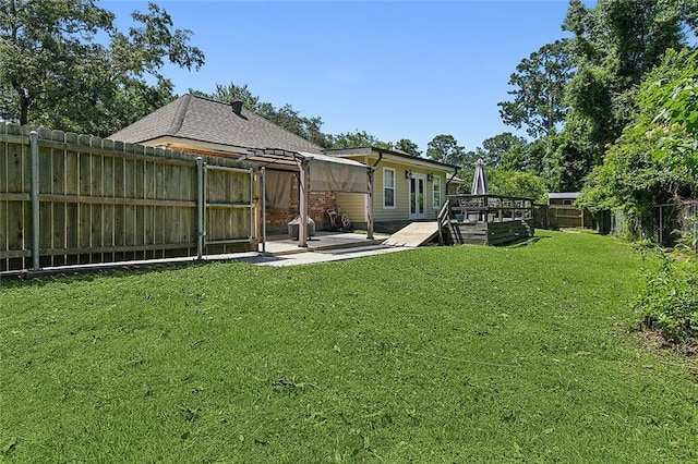 back of house featuring a lawn and a wooden deck