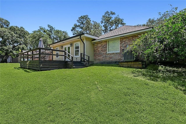 exterior space featuring a lawn and a deck