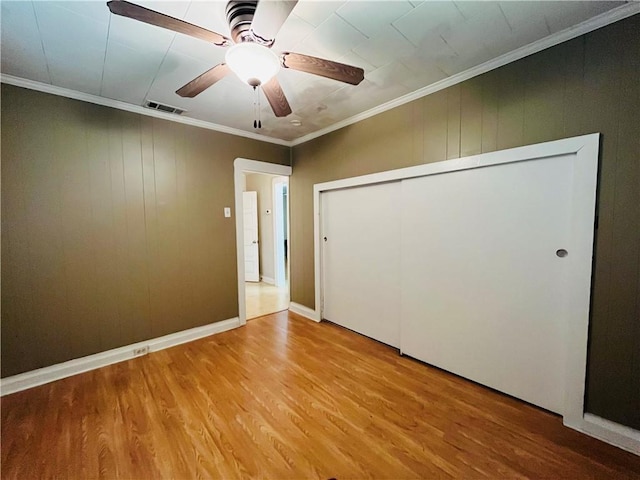 651 Avenue E Ave E, Westwego, LA 70094 - unfurnished bedroom featuring wood finished floors, a ceiling fan, crown molding, and a closet