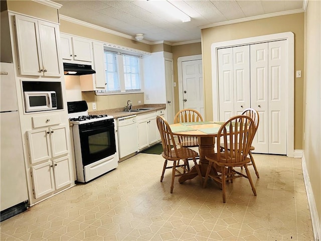 651 Avenue E Ave E, Westwego, LA 70094 - kitchen with white appliances, under cabinet range hood, crown molding, white cabinets, and light tile patterned floors