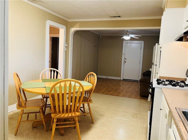 651 Avenue E Ave E, Westwego, LA 70094 - dining space with ceiling fan, crown molding, and light wood-type flooring