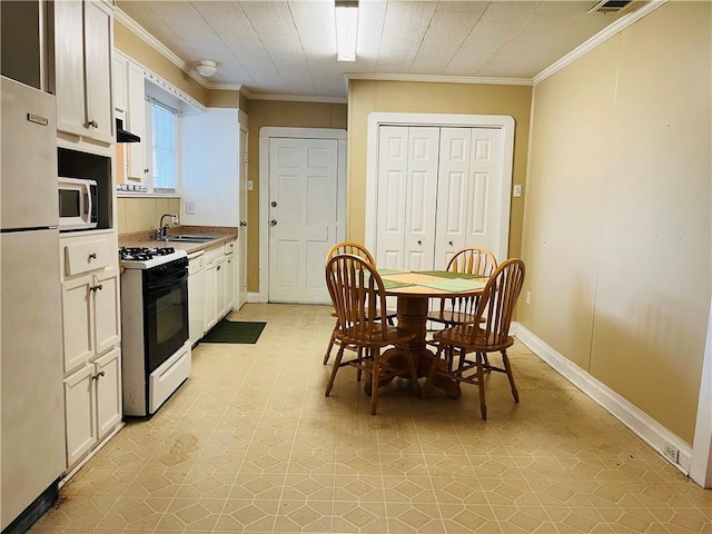 651 Avenue E Ave E, Westwego, LA 70094 - kitchen featuring white appliances, white cabinets, crown molding, and ventilation hood