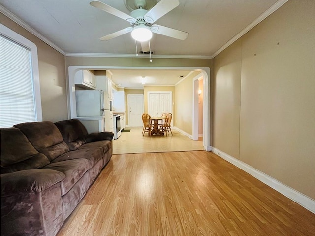 651 Avenue E Ave E, Westwego, LA 70094 - living room with arched walkways, light wood-type flooring, ceiling fan, and crown molding