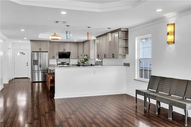 kitchen with dark hardwood / wood-style flooring, stainless steel refrigerator with ice dispenser, crown molding, kitchen peninsula, and gray cabinetry