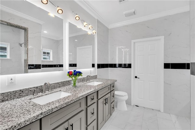 bathroom featuring tile walls, double vanity, ornamental molding, toilet, and tile patterned flooring