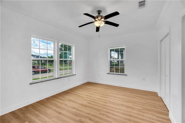 unfurnished room with light hardwood / wood-style floors, ceiling fan, and crown molding