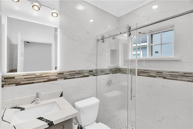 bathroom featuring tile walls, toilet, vanity, and an enclosed shower