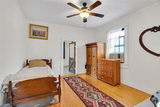 bedroom with cooling unit, ceiling fan, ornamental molding, and hardwood / wood-style floors