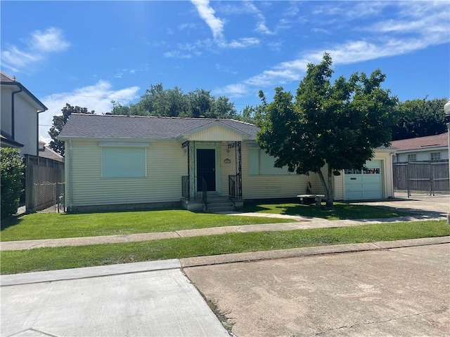 view of front of property with a front yard and a garage