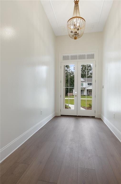 interior space with french doors, a chandelier, and dark hardwood / wood-style flooring