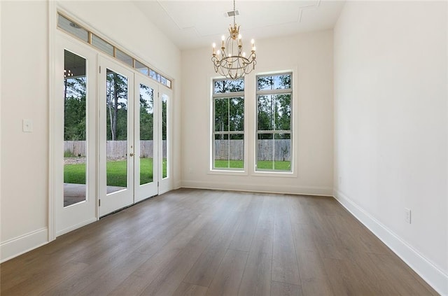 entryway featuring french doors, hardwood / wood-style flooring, an inviting chandelier, and a wealth of natural light