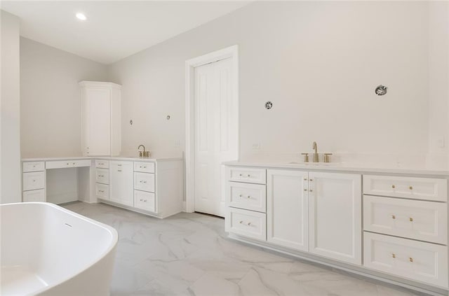 bathroom featuring vanity and a bath