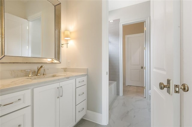 bathroom featuring vanity and a washtub