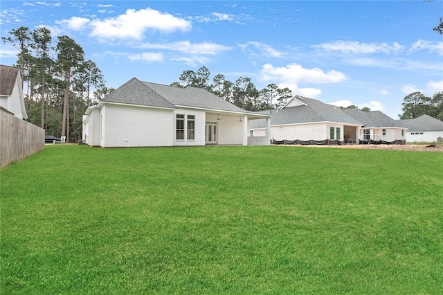 rear view of property with a lawn