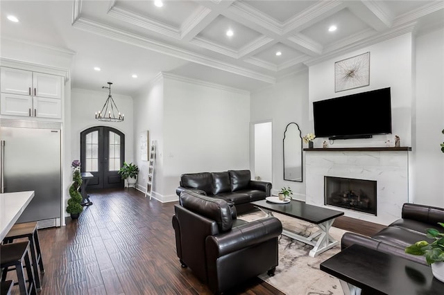 living room featuring french doors, crown molding, dark hardwood / wood-style flooring, and a notable chandelier