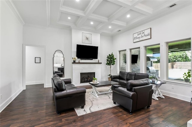 living room with dark wood-type flooring, a towering ceiling, coffered ceiling, beam ceiling, and a fireplace