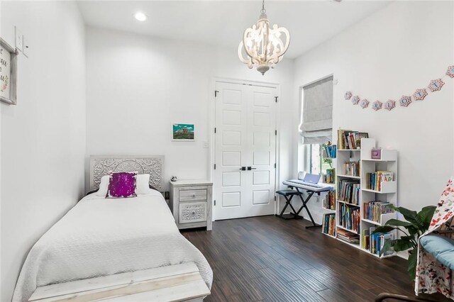 bedroom featuring a notable chandelier and dark hardwood / wood-style floors