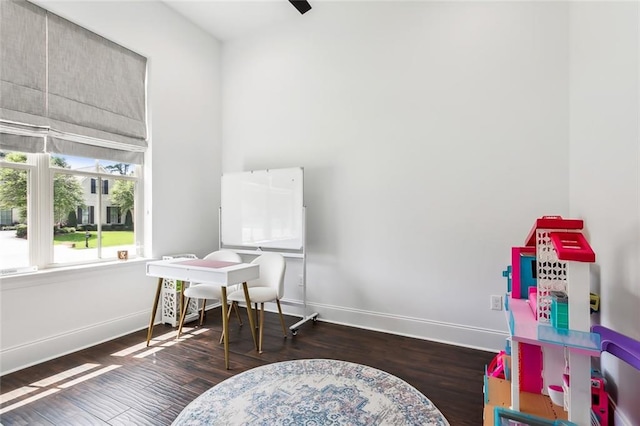 recreation room with dark wood-type flooring