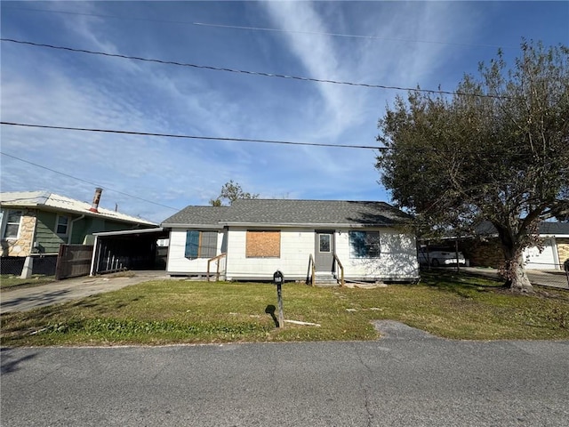 view of front of property with a front lawn and a carport