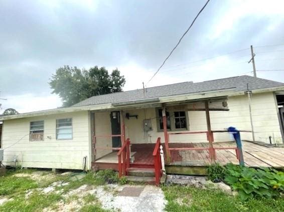 back of property with covered porch