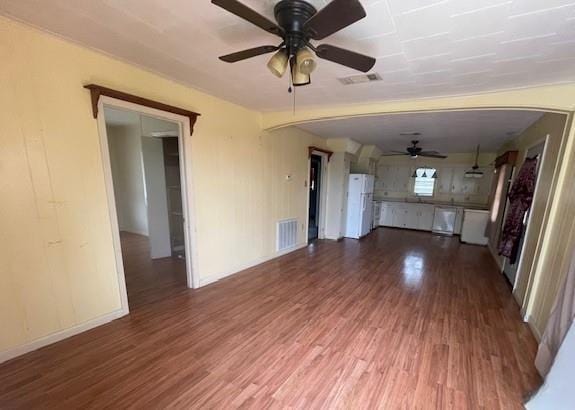 unfurnished living room featuring ceiling fan and wood-type flooring