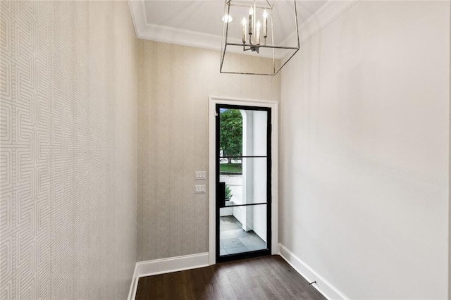 doorway to outside featuring a notable chandelier, ornamental molding, and dark hardwood / wood-style floors