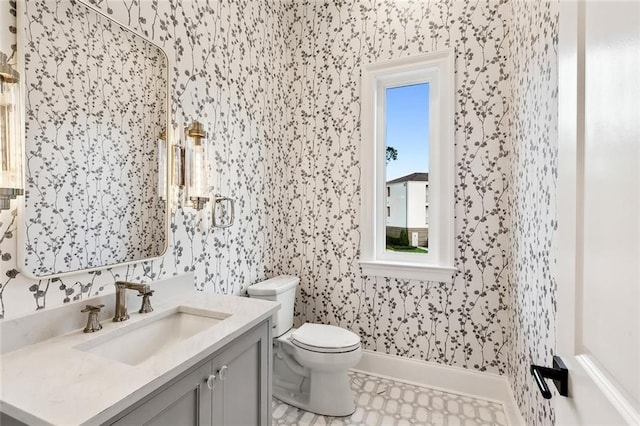 bathroom with vanity, toilet, and tile floors