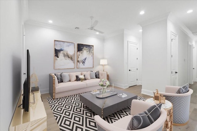 living room with wood-type flooring, ornamental molding, and ceiling fan