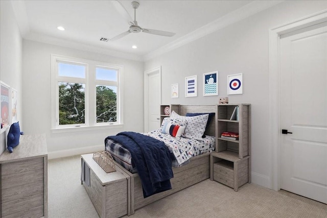 carpeted bedroom featuring ceiling fan and crown molding