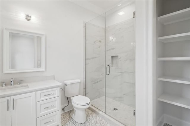 bathroom featuring tile floors, an enclosed shower, toilet, and large vanity