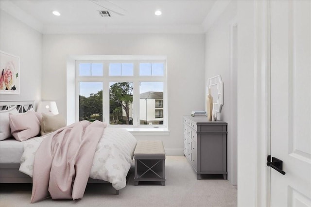 bedroom with crown molding and light colored carpet