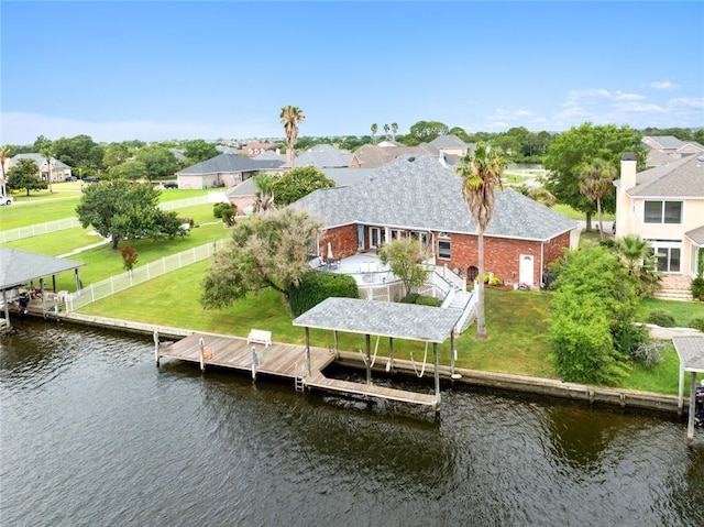 dock area with a lawn and a water view