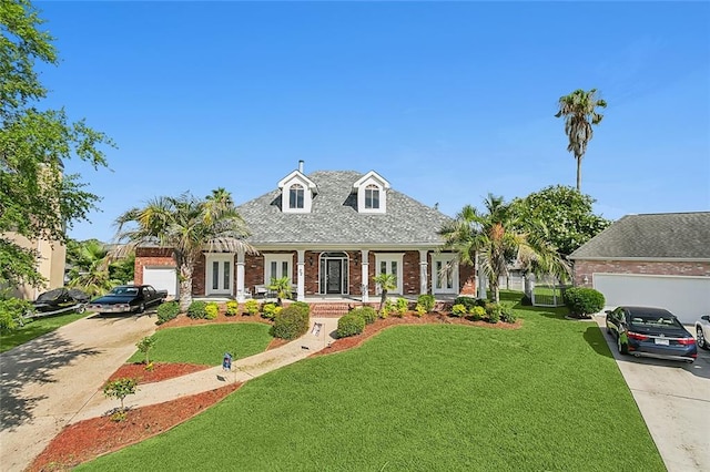 cape cod house with a garage and a front lawn