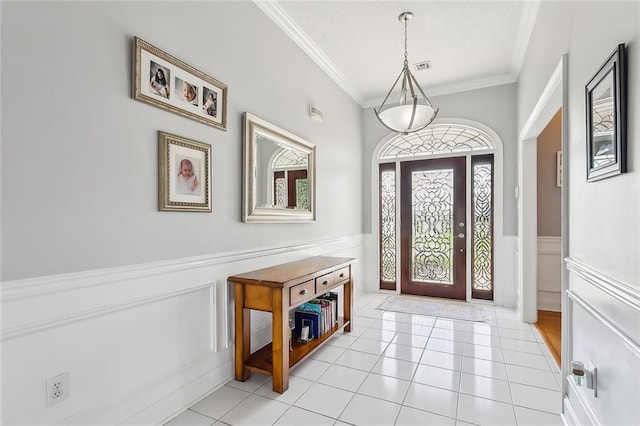 entryway featuring light tile patterned floors and ornamental molding