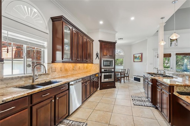 kitchen featuring appliances with stainless steel finishes, light tile patterned floors, crown molding, and sink