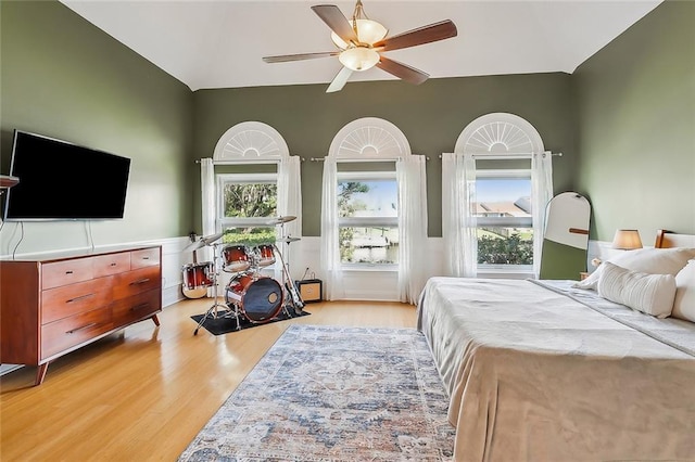 bedroom with ceiling fan and light hardwood / wood-style floors