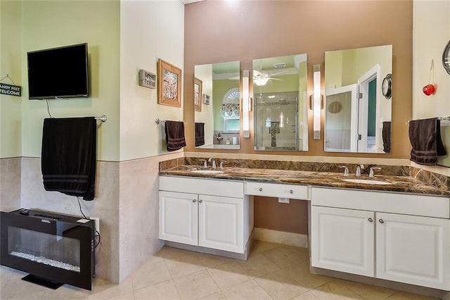 bathroom featuring tile patterned flooring, vanity, heating unit, and walk in shower