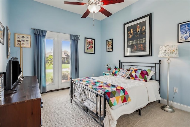 bedroom with ceiling fan, light colored carpet, and multiple windows