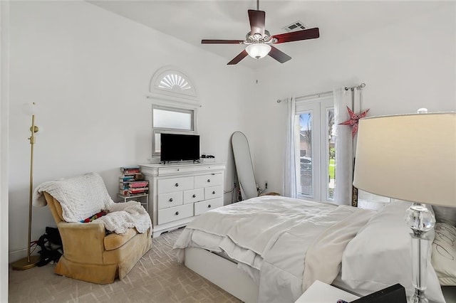 bedroom with ceiling fan and light carpet